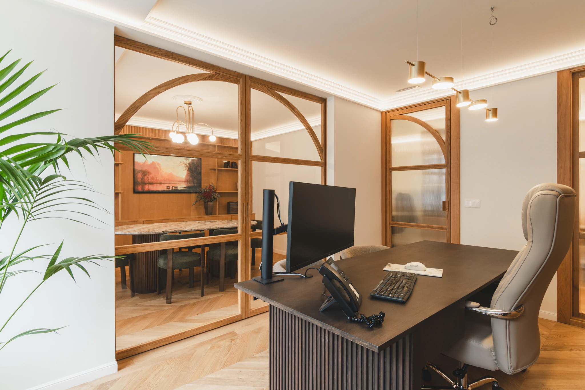 La mesa de trabajo del despacho con la mampara de arco al fondo